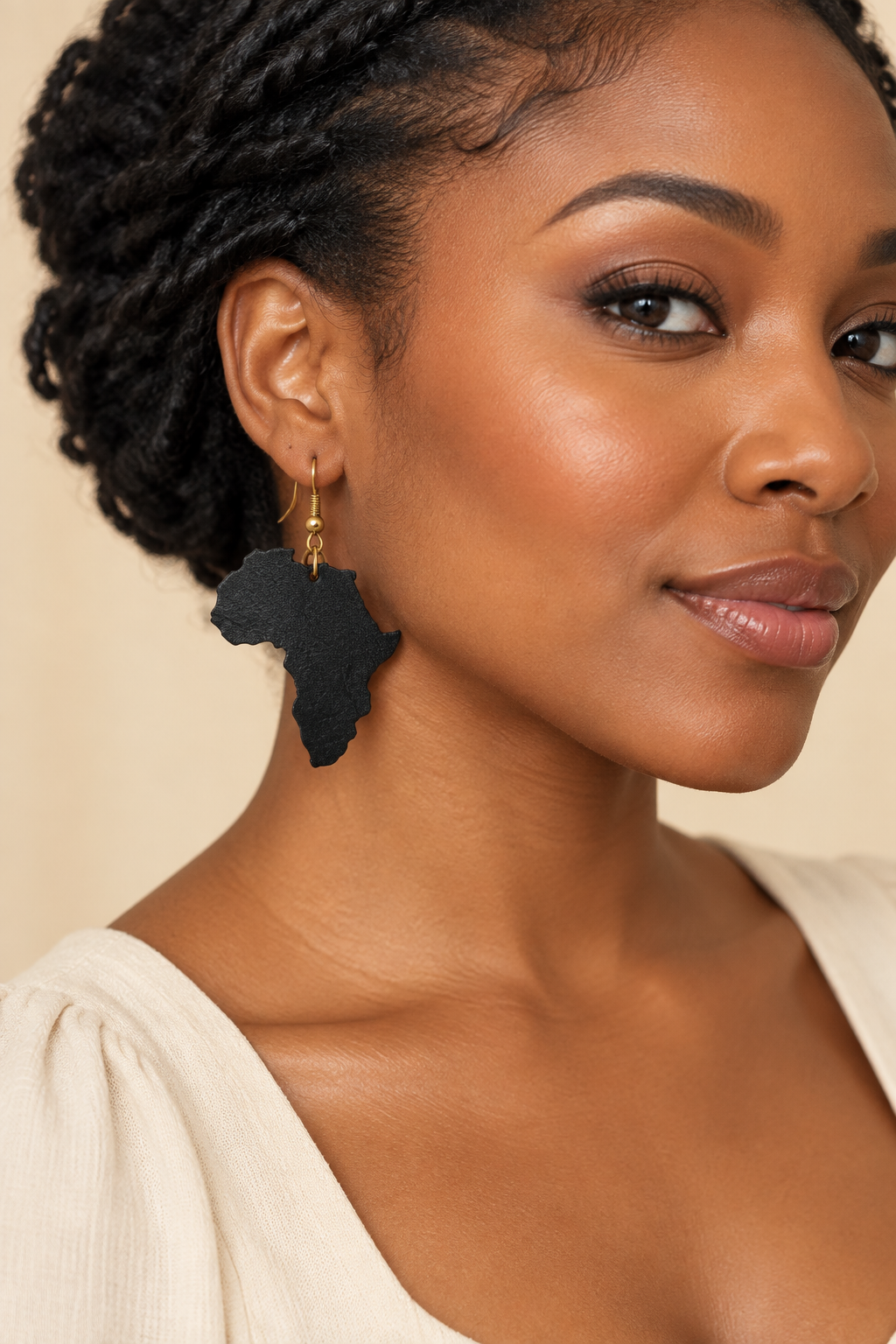 Model wearing black Africa-shaped leather earring