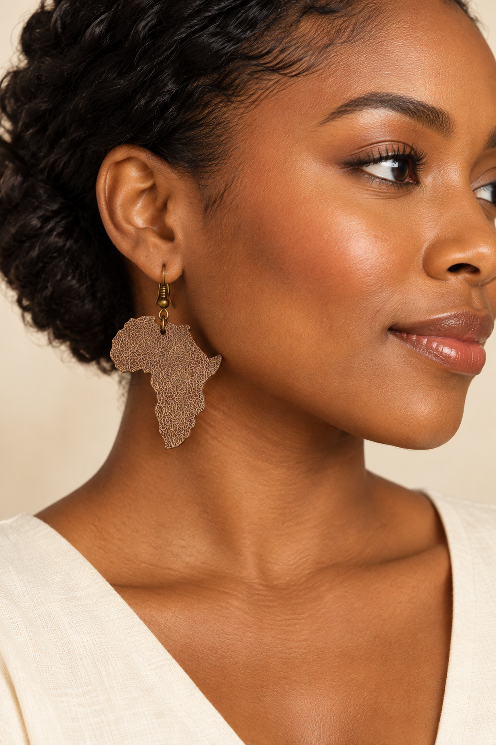 Model wearing brown Africa-shaped leather earrings